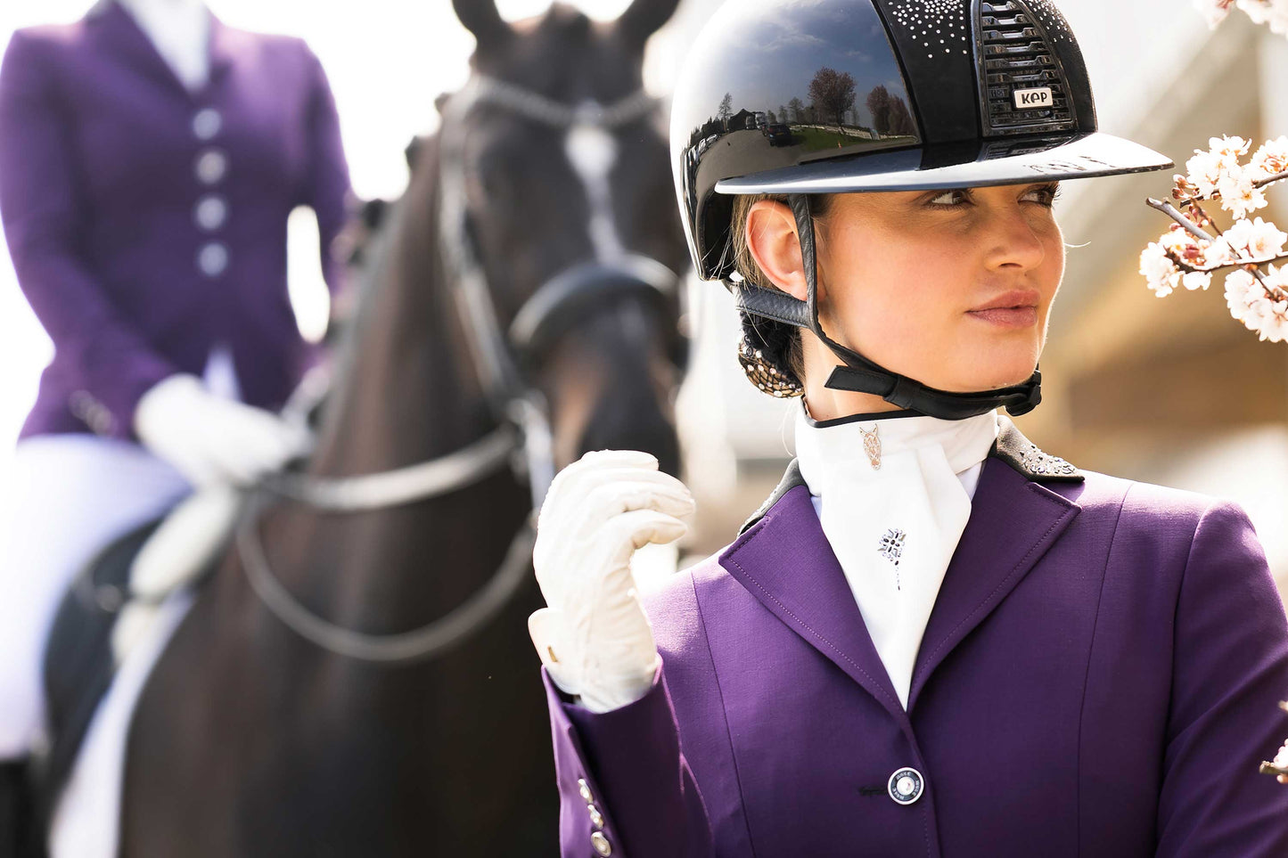 Detail from the top of the purple JuulC' Ladies' Competition Jacket in Shadow Amethyst with horse in the background
