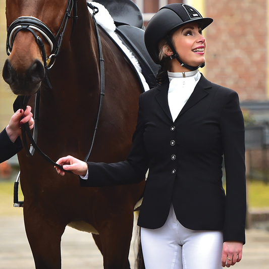 Model with horse wearing JuulC' Classic Black Women's Show Coat made from sport-tech merino wool