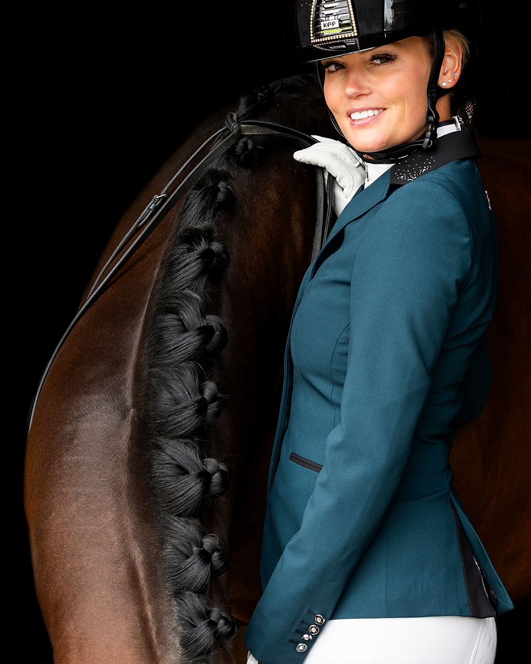 Side of Emerald JuulC Ladies' Competition Jacket with black collar and Swarovski crystals, worn by model
