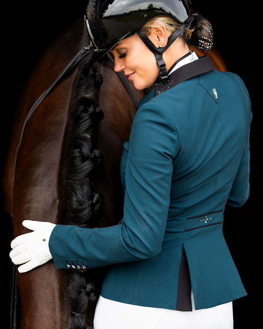 Model showing the back of JuulC Ladies' competition jacket in Emerald with black contrasts and Swarovski design on the back strap