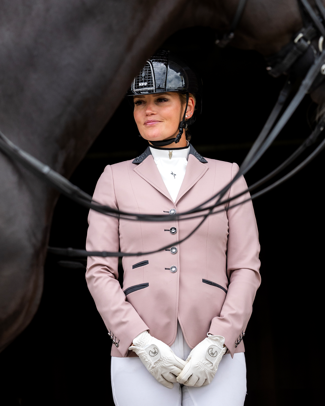 Front of JuulC Women's Show Coat in Powder Pink with anthracite grey accents and Swarovski crystals, worn by model